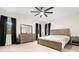 Bright bedroom with a king-size bed, dresser, and ceiling fan at 1012 Fernleaf Run, Bradenton, FL 34212