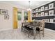 Dining room with rustic farmhouse table, bench and gallery wall at 1012 Fernleaf Run, Bradenton, FL 34212