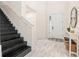 Elegant entryway with dark wood stairs and a modern console table at 1012 Fernleaf Run, Bradenton, FL 34212