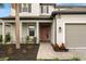 Front entrance with a walkway, landscaping, and a two-car garage at 1012 Fernleaf Run, Bradenton, FL 34212