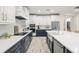 Spacious kitchen with two-toned cabinets, quartz countertops, and stainless steel appliances at 1012 Fernleaf Run, Bradenton, FL 34212