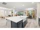 Modern kitchen with a farmhouse sink, white quartz countertops and dark blue cabinets at 1012 Fernleaf Run, Bradenton, FL 34212