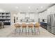 Modern kitchen with white and blue cabinets, island, and stainless steel appliances at 1012 Fernleaf Run, Bradenton, FL 34212