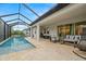 Relaxing pool area with covered patio and seating at 1012 Fernleaf Run, Bradenton, FL 34212