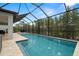 Long rectangular pool with a screened enclosure and a patio at 1012 Fernleaf Run, Bradenton, FL 34212