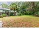 Spacious backyard with lush greenery and a large grassy area at 1130 Anclote Rd Rd, Tarpon Springs, FL 34689