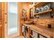 Rustic bathroom with concrete vanity, wooden shelves, and industrial accents at 1130 Anclote Rd Rd, Tarpon Springs, FL 34689