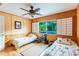 Bedroom with two twin beds, a ceiling fan, and Japanese-inspired decor at 1130 Anclote Rd Rd, Tarpon Springs, FL 34689