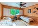 Bedroom with two twin beds, a ceiling fan, and Japanese-inspired decor at 1130 Anclote Rd Rd, Tarpon Springs, FL 34689