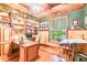 Bright home office with hardwood floors and ample built-in shelving at 1130 Anclote Rd Rd, Tarpon Springs, FL 34689