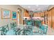 Eat-in kitchen with glass-top table and unique turquoise chairs at 1130 Anclote Rd Rd, Tarpon Springs, FL 34689