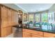 Kitchen with farmhouse sink, granite countertop, and sliding barn door at 1130 Anclote Rd Rd, Tarpon Springs, FL 34689