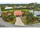 An aerial view of a single story home with a red tile roof in a residential neighborhood at 1212 Windward Dr, Osprey, FL 34229