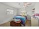 Bright bedroom with a bed, dresser, and window coverings at 1212 Windward Dr, Osprey, FL 34229