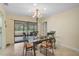 Charming dining room with glass table, metal chairs, and view of the backyard at 1212 Windward Dr, Osprey, FL 34229