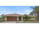 Single-story house with tile roof, attached garage, and landscaped yard at 1212 Windward Dr, Osprey, FL 34229