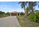 Charming house exterior with a driveway and landscaping at 1212 Windward Dr, Osprey, FL 34229