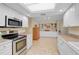 Modern kitchen with stainless steel appliances and white cabinets at 1212 Windward Dr, Osprey, FL 34229