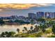 Stunning sunset view of waterfront cityscape with palm trees and marina at 1233 N Gulfstream Ave # 502, Sarasota, FL 34236