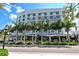 White hotel with palm trees and outdoor seating area at 1233 N Gulfstream Ave # 502, Sarasota, FL 34236