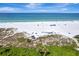 Stunning aerial view of a pristine beach with turquoise water and white sand at 1255 E Peppertree Dr # 402, Sarasota, FL 34242