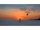 Person flying a kite on the beach at sunset at 1255 E Peppertree Dr # 402, Sarasota, FL 34242