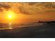 Stunning sunset over the beach with people enjoying the view at 1255 E Peppertree Dr # 402, Sarasota, FL 34242