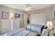 Bright bedroom with twin beds, dresser, and access to a balcony at 1255 E Peppertree Dr # 402, Sarasota, FL 34242