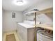 Laundry room with washer, dryer, and extra shelving at 1255 E Peppertree Dr # 402, Sarasota, FL 34242