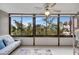 Sunroom with ample natural light and a view of the trees at 1255 E Peppertree Dr # 402, Sarasota, FL 34242