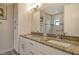 Elegant bathroom with double vanity, granite countertop, and large mirror at 1273 Boulevard Of The Arts, Sarasota, FL 34236