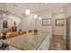 Granite kitchen island with seating overlooking the living room at 1273 Boulevard Of The Arts, Sarasota, FL 34236