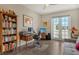 Home office with built-in shelving, desk, and balcony access at 1273 Boulevard Of The Arts, Sarasota, FL 34236