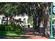 Brick walkway lined with trees and benches at 1273 Boulevard Of The Arts, Sarasota, FL 34236