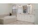 Bathroom boasts a large vanity, soaking tub, and tiled floors at 1507 91St Nw Ct, Bradenton, FL 34209