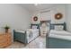 Bedroom with twin beds, light walls, and coastal decor at 1507 91St Nw Ct, Bradenton, FL 34209