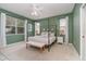 Main bedroom with canopy bed, sitting bench, and green walls at 1507 91St Nw Ct, Bradenton, FL 34209