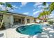 Inviting kidney-shaped pool with stone deck and solar panels at 1507 91St Nw Ct, Bradenton, FL 34209