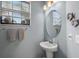 Simple bathroom with pedestal sink and oval mirror at 15147 Lyla Ter, Bradenton, FL 34211