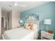 Bedroom with light blue accent wall and a queen-size bed at 15147 Lyla Ter, Bradenton, FL 34211