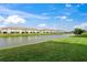 Stunning view of lake and community from a grassy backyard at 15147 Lyla Ter, Bradenton, FL 34211