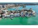 Aerial view of waterfront community showcasing upscale buildings and a marina at 166 Golden Gate Pt # 21, Sarasota, FL 34236