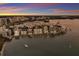 Breathtaking aerial view of waterfront homes at sunset at 166 Golden Gate Pt # 21, Sarasota, FL 34236