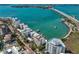 Aerial view of waterfront buildings and a marina near a bridge at 166 Golden Gate Pt # 21, Sarasota, FL 34236