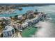 Wide aerial view of waterfront buildings and a marina with boats at 166 Golden Gate Pt # 21, Sarasota, FL 34236