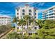 Luxury building, lush landscaping, and waterfront location at 166 Golden Gate Pt # 21, Sarasota, FL 34236