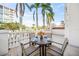 Private balcony with table and chairs, perfect for outdoor dining at 166 Golden Gate Pt # 21, Sarasota, FL 34236