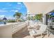 Balcony with lounge chairs and waterfront views at 166 Golden Gate Pt # 21, Sarasota, FL 34236