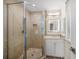 Small bathroom with shower, single sink, and window at 166 Golden Gate Pt # 21, Sarasota, FL 34236