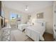 Guest bedroom with twin beds and balcony access at 166 Golden Gate Pt # 21, Sarasota, FL 34236